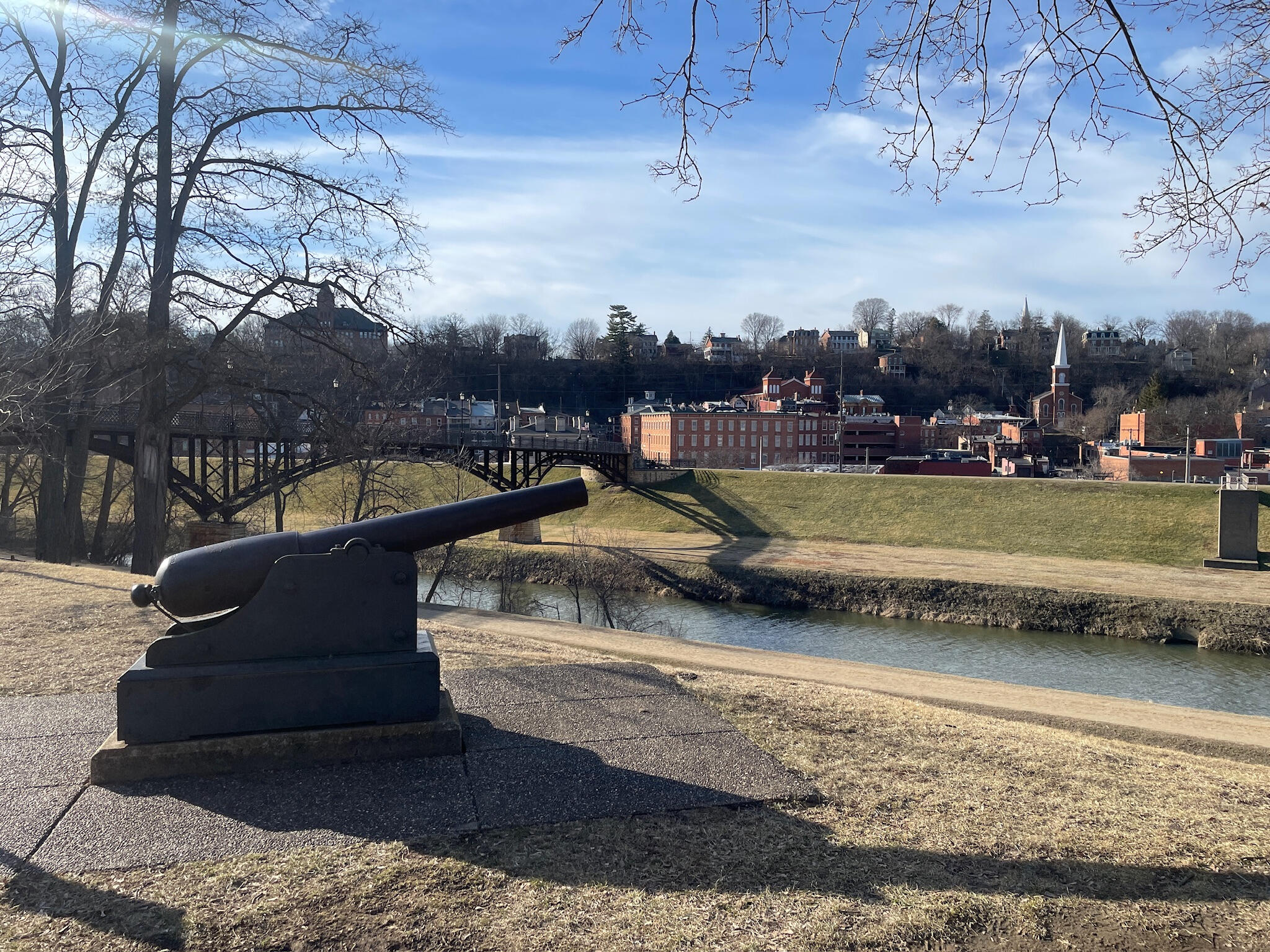 galena-illinois-grant-park-cannon-river A historic black cannon in Grant Park overlooking the Galena River and the downtown skyline of Galena, Illinois.