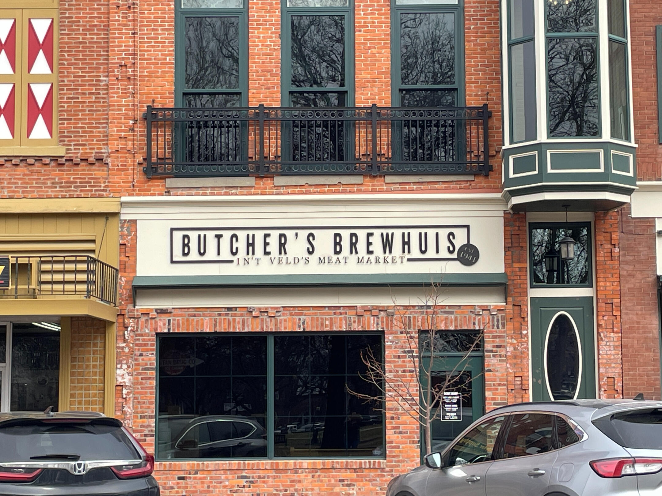 pella-butchers-brewhuis-asylum-bar-exterior Exterior of Butcher’s Brewhuis and The Asylum bar on a brick downtown block in Pella.